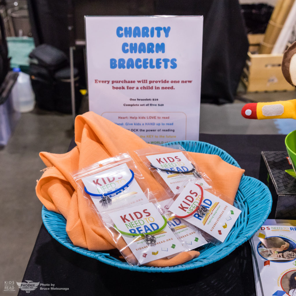 kids need to read charity bracelets comicon