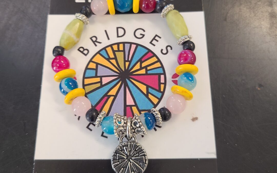 The Meaningful Story Behind the Bridges Re-Entry Logo Charm Bracelet