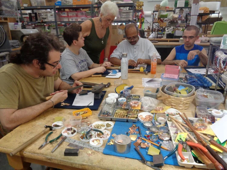 SEEDs for Autism participants working at jewelry assembly table with instructors